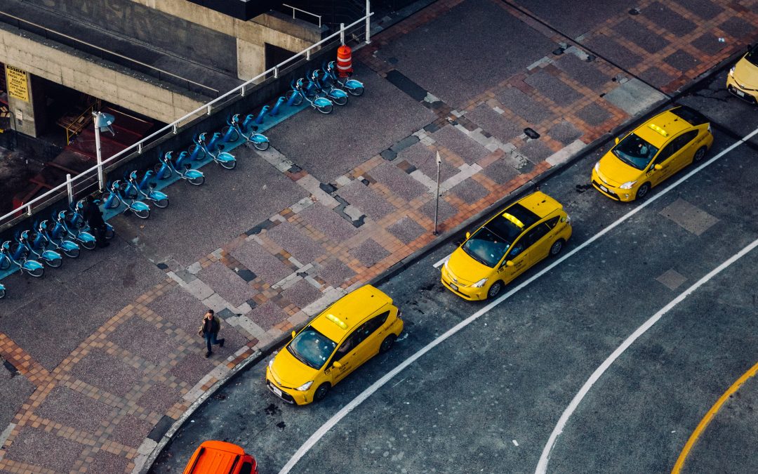yellow taxi on road during daytime