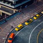 yellow taxi on road during daytime